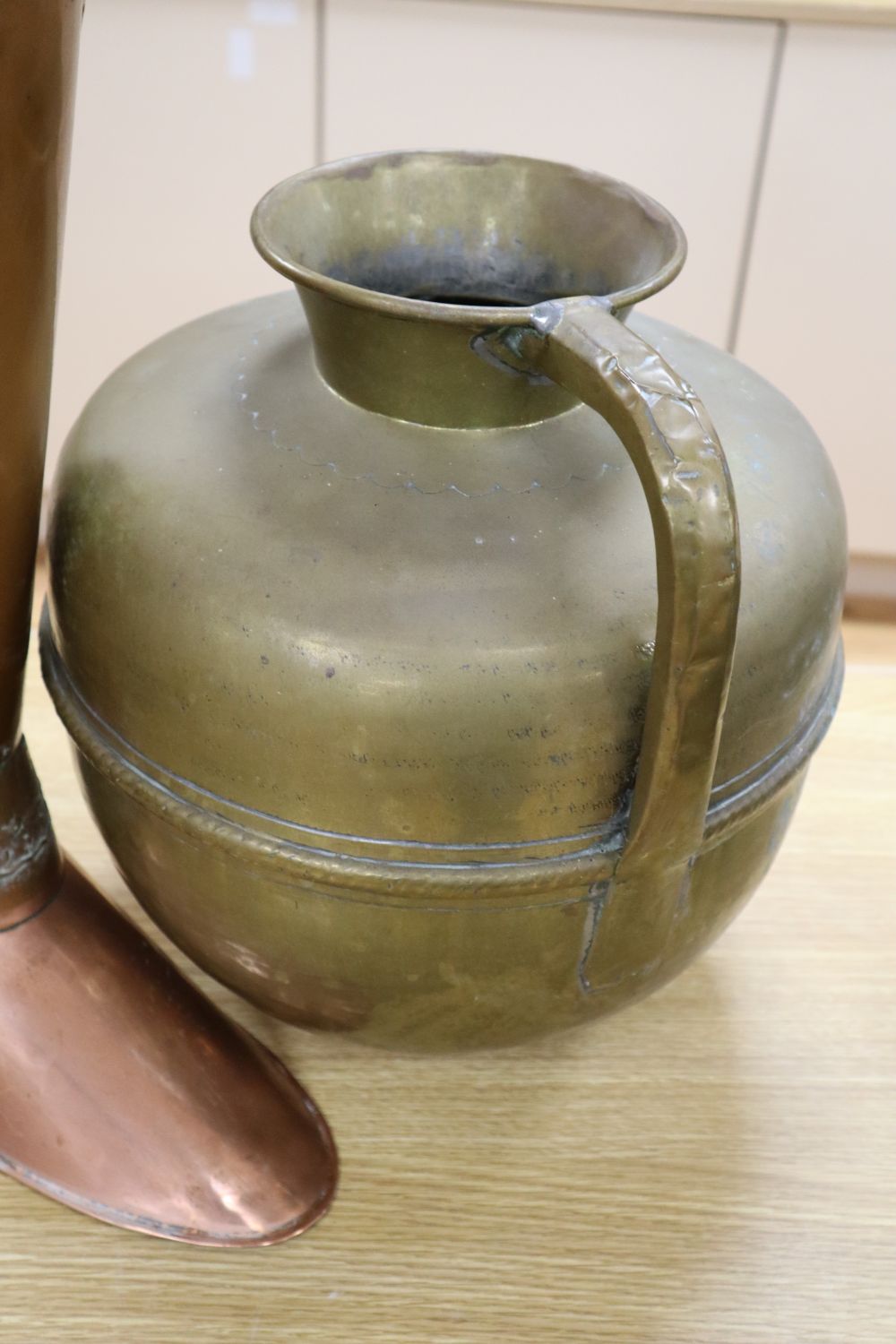 A copper stickstand shaped as a riding boot, height 52cm, two silver mounted walking sticks and a large brass jug, height 35cm